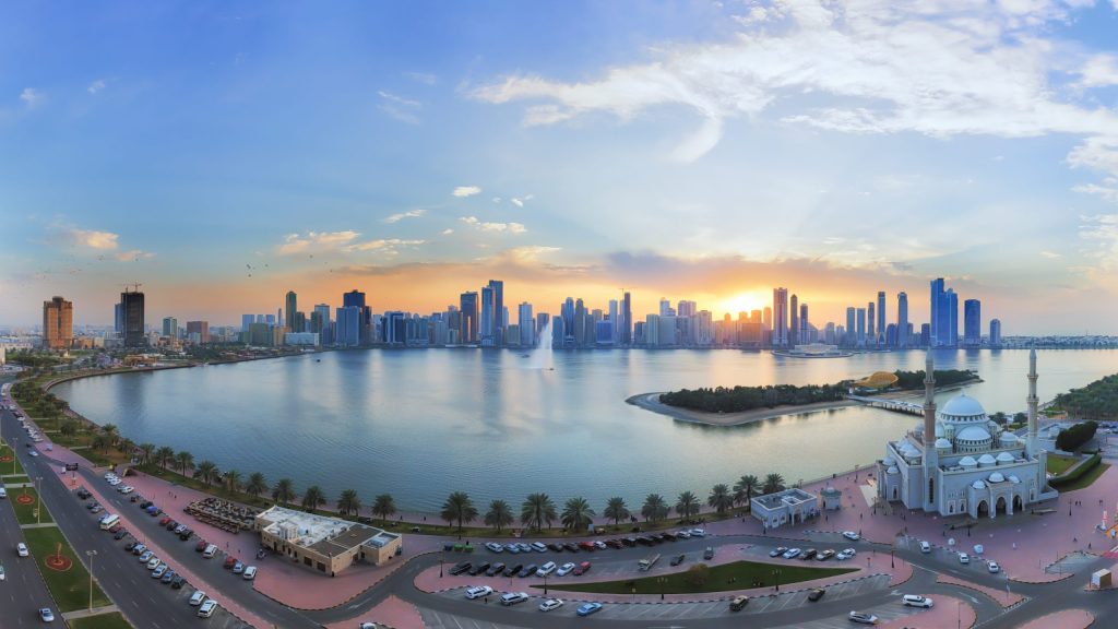 Sharjah skyline at sunset with business district view.