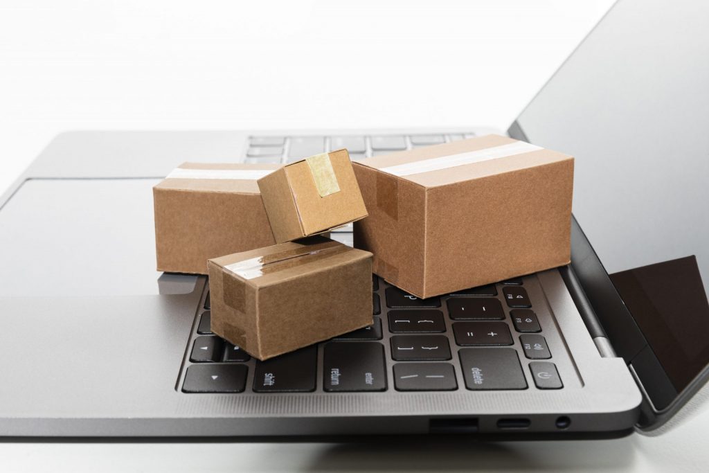 Small cardboard boxes on a laptop keyboard.